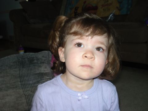2000 Ford Crown Victoria - A young child looks off to the side while sitting indoors.