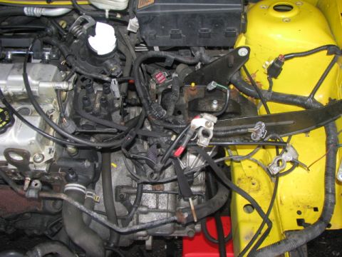 2003 Ford Focus - Close-up view of a vehicle's engine compartment, showing various mechanical parts and wiring.