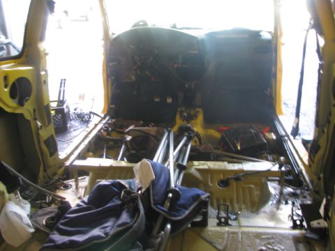 2003 Ford Focus - Car interior stripped down, showing exposed wiring and removed seats.