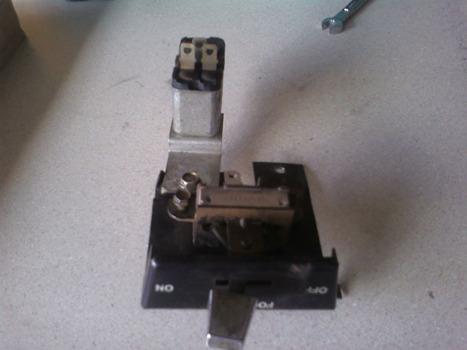 automotive electrical relay and switch assembly with 'ON' and 'OFF' labels