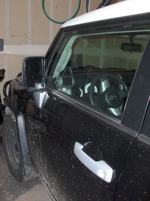 2008 Toyota FJ Cruiser - Interior view of a black Toyota FJ Cruiser, showing the dashboard and steering wheel.