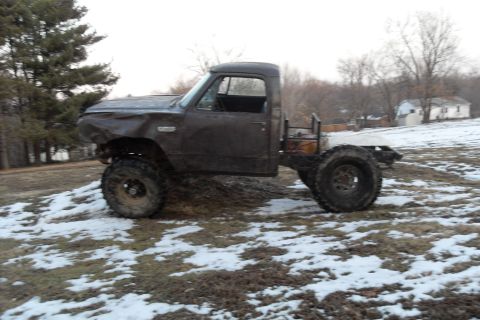 1980 Dodge Magnum - This heavily modified pickup truck appears to be a project vehicle, with significant body damage and a custom lift.