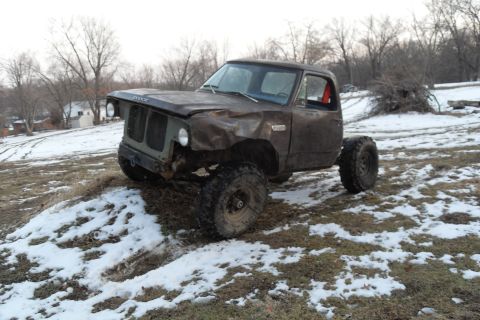1980 Dodge Magnum - This heavily modified Dodge pickup truck, likely from the 1970s, is shown with significant front-end damage and oversized tires.