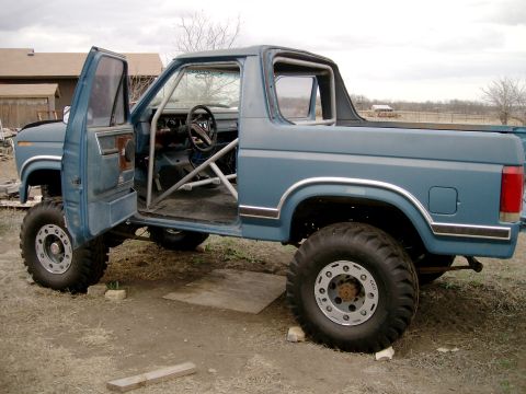 1984 Ford Bronco - This modified SUV features a prominent roll cage and off-road tires, suggesting it's built for terrain.