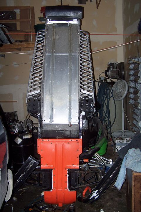 2004 Arctic Cat F-7 Firecat - The underside of a snowmobile chassis is shown, an orange plastic guard and a metal track bed.
