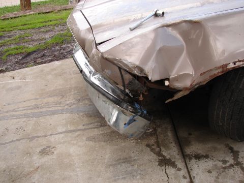 1973 Ford Ranchero - Front end damage on a 1973 Ford Ranchero, showing a bent chrome bumper and crumpled fender.
