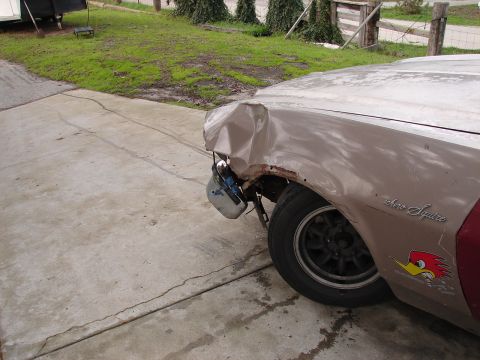 1973 Ford Ranchero - A damaged 1973 Ford Ranchero Squire shows significant front-end damage and rust on the fender.