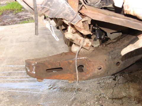 1973 Ford Ranchero - Close-up of a heavily damaged vehicle frame, showing rust and structural compromise.