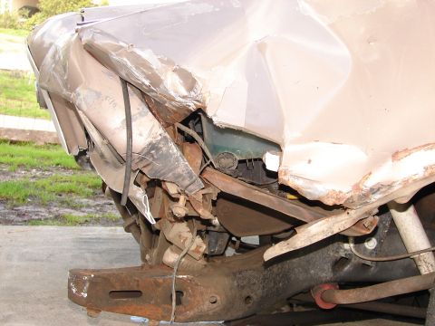1973 Ford Ranchero - Front end damage is extensive, revealing structural and mechanical components beneath the crumpled body panels.