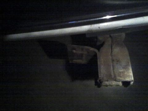 1996 Ford Bronco - A close-up view of a vehicle's undercarriage reveals a metal component, likely part of the suspension or hitch system.