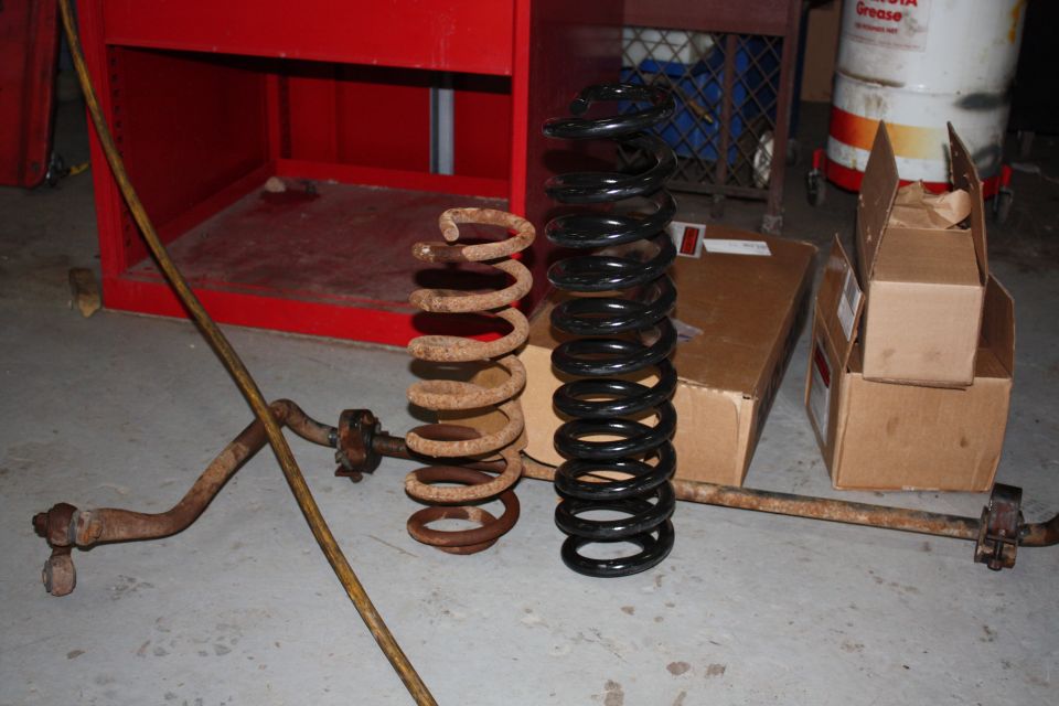 Rough Country 6 inch lift spring next to stock spring