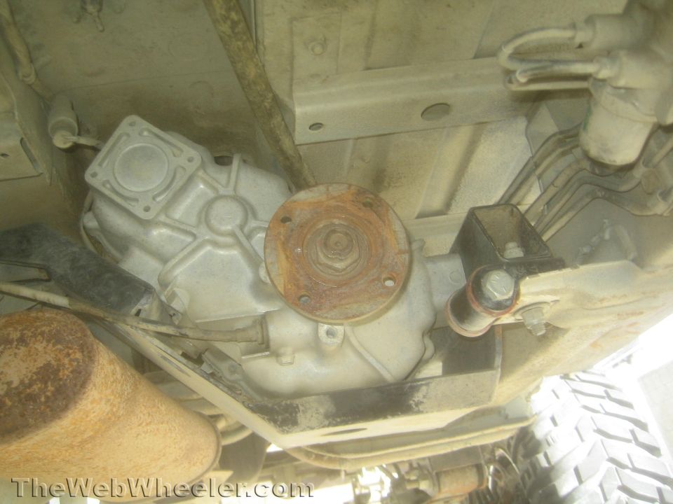 Underside view of a transfer case output flange and crossmember