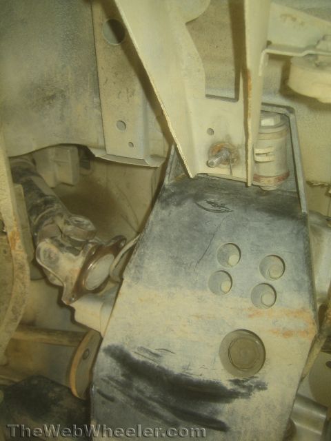 1987 Suzuki Samurai - Photo from beneath a 4x4 showing a skid plate, mounting bracket, stud and steering components.