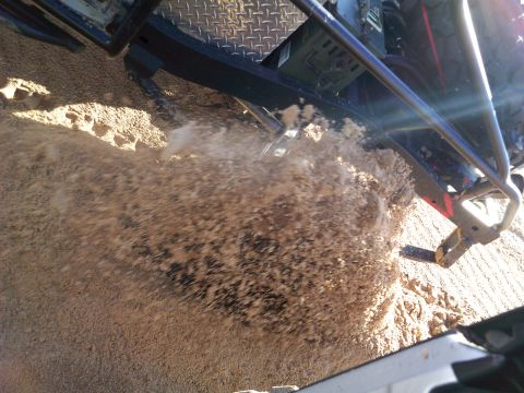 2004 Jeep Wrangler - A close-up, high-angle shot shows a vehicle's tire kicking up a large cloud of dirt and debris. The vehicle's frame and part of its tire ar…