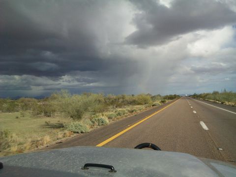 2004 Jeep Wrangler - Driving on a highway through a desert landscape as a storm approaches.
