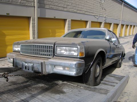 1991 Ford LTD Crown Victoria - This Chevrolet Caprice, likely from the early to mid-1980s, is being towed.