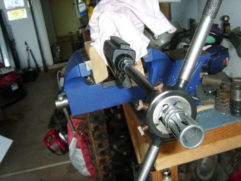 1978 Ford Bronco - A gun barrel is secured in a vise, ready for threading work.