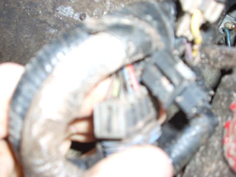 2000 Chevrolet Tahoe - A close-up view of a vehicle's electrical wiring harness, showing various connectors and bundled wires.