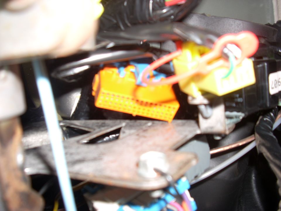 Orange and yellow wiring harness connectors with red and blue wires