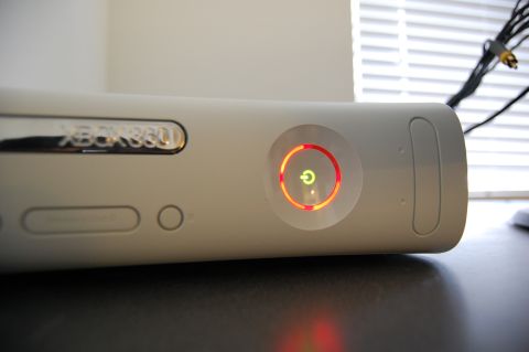 2002 BMW M3 - Close-up of an Xbox 360 console, showing the power button with red ring error indicators.