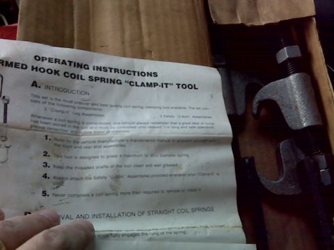 2008 Jeep Wrangler - Operating instructions for a coil spring compressor tool are shown next to the tool itself.