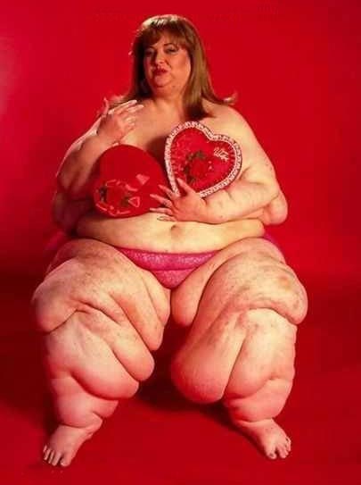 1989 Ford Bronco - A woman sits against a red backdrop, holding two heart-shaped boxes of candy.