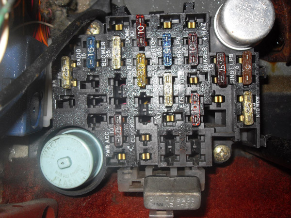 Automotive fuse box with multiple colored blade fuses and labels