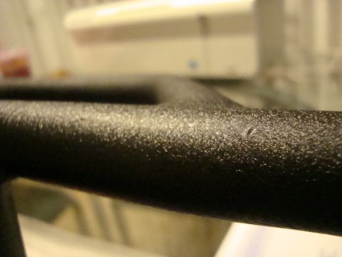 1995 Mazda MX-6 - Close-up of textured black plastic interior trim, showing a small imperfection.