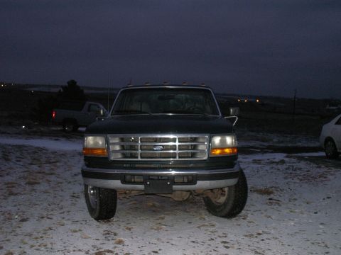 1997 Ford F-250 - A 1997 Ford F-250 pickup truck is seen from the front in a snowy outdoor setting.