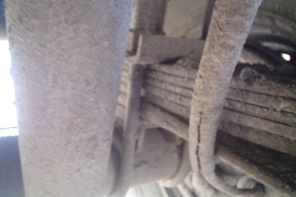 Close-up of vehicle leaf spring and suspension parts