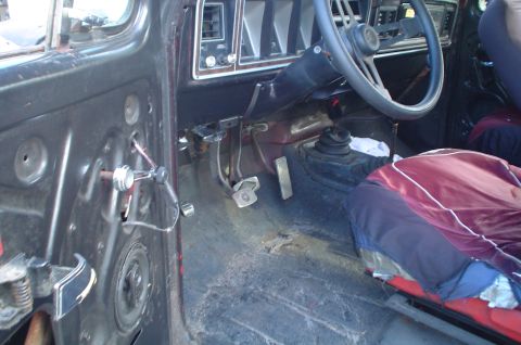 1979 Ford Bronco - The interior of a 1979 Ford Bronco, its dashboard, steering wheel, and seat covers.