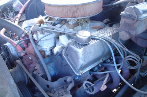 1979 Ford Bronco - Close-up view of an engine bay, showing various components like valve covers and an air cleaner.