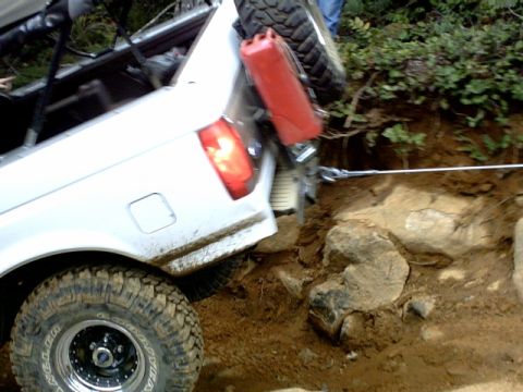 1995 Ford Bronco - This vehicle appears to be stuck on a challenging off-road trail, requiring assistance to move forward.