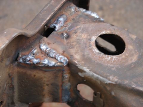 1973 Ford Ranchero - Detail of a welded metal frame component, showing signs of repair and age.