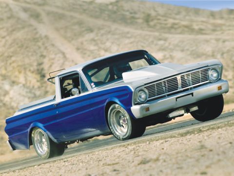 1983 Ford Bronco - A modified pickup truck with a two-tone paint job is captured in motion on a dusty, arid landscape.
