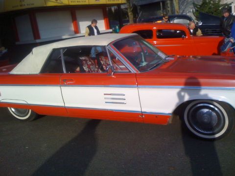 1983 Ford Bronco - A two-tone convertible is parked next to other vehicles.