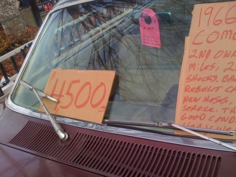 1983 Ford Bronco - A sign on a car windshield advertises a 1966 vehicle for sale.