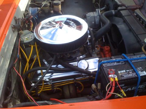 1983 Ford Bronco - Engine bay details showing chrome air cleaner, battery, and various hoses and wires.