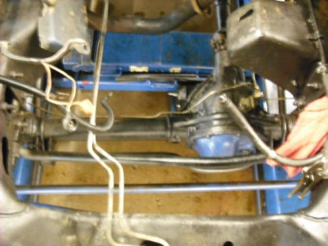 1979 Ford Bronco - Close-up view of a vehicle's undercarriage, showing suspension and brake lines.