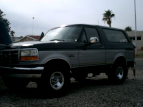 1994 Ford Bronco - Side view of a two-tone 1994 Ford Bronco.
