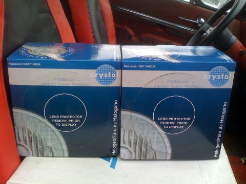 1983 Ford Bronco - Two blue boxes of Crystal brand lens protectors for halogen headlights are displayed. Text on the boxes indicates they replace H6017/H6024…