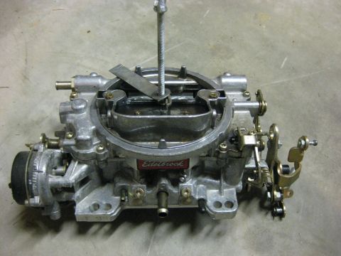1979 Ford Bronco - A close-up, overhead view of an Edelbrock carburetor, likely for a classic vehicle, resting on a concrete floor.