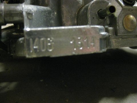 1979 Ford Bronco - A close-up view shows a metal plate with stamped numbers '1408 1314' on a part of a vehicle. The part appears to be a carburetor.
