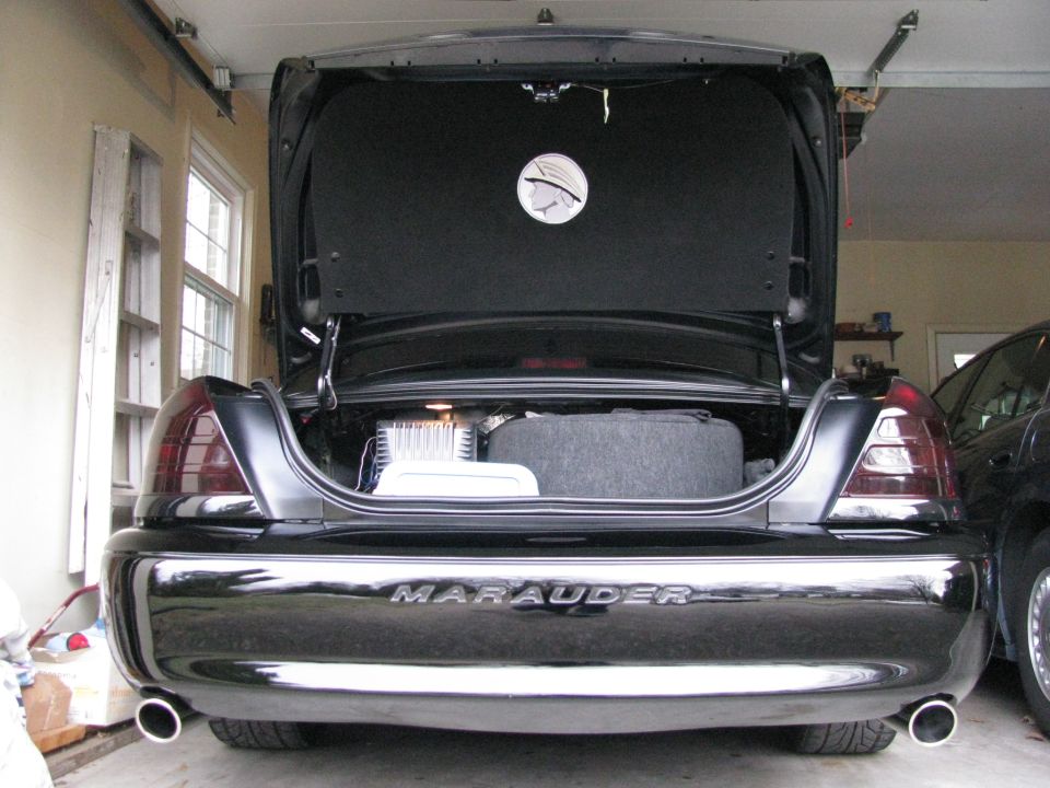 Open trunk of a black Mercury Marauder sedan in a garage