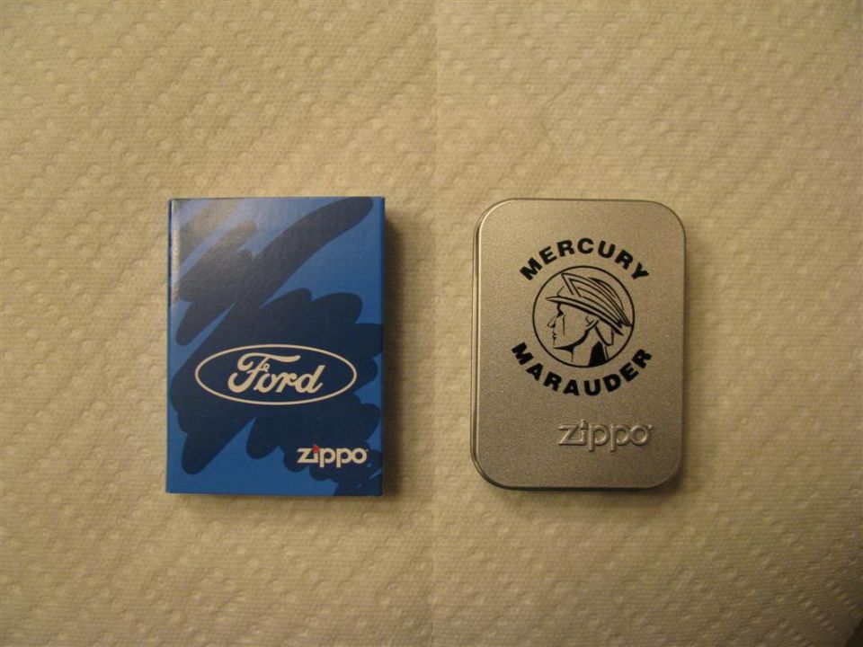 Two Zippo lighters: blue Ford logo and silver Mercury Marauder tin