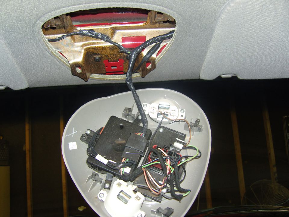 Photo of a removed overhead console showing internal wiring and motors