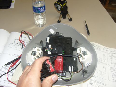 2007 Ford Mustang - Photograph of a technician probing an overhead console connector during testing, not a technical document.