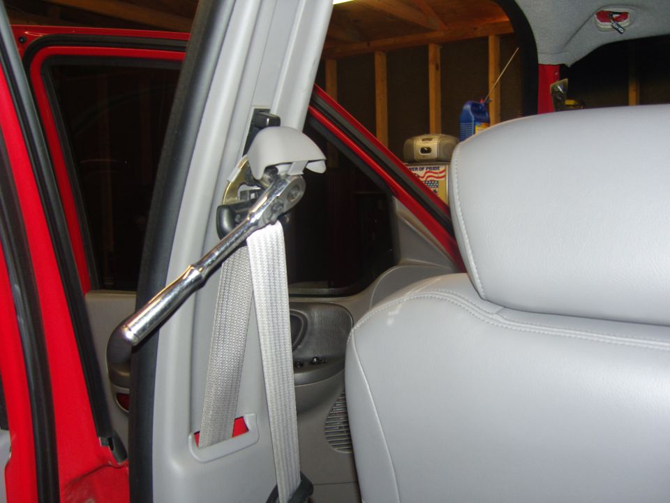 Photo of a vehicle B-pillar seat belt anchor with a ratchet