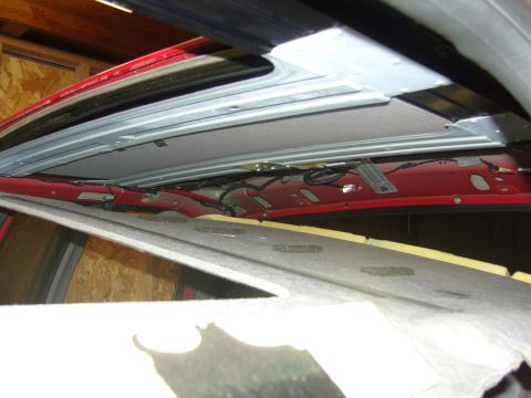 2007 Ford Mustang - Photograph of a truck roof rail and partly removed headliner exposing the metal structure, not a document.