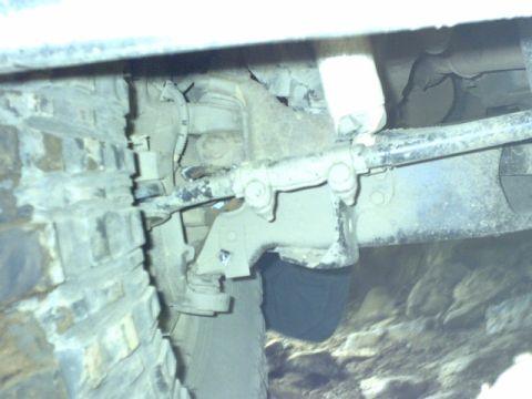 1995 Ford Bronco - This image shows a detailed view of the undercarriage, focusing on the suspension and tire assembly.